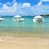 3 floating cabanas in the waters of a tropical beach